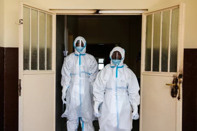 Medics in full safety gear at the entrance to a new isolation unit at the Connaught Hospital in Freetown, Sierra Leone. Credit: Simon Davis/DFID